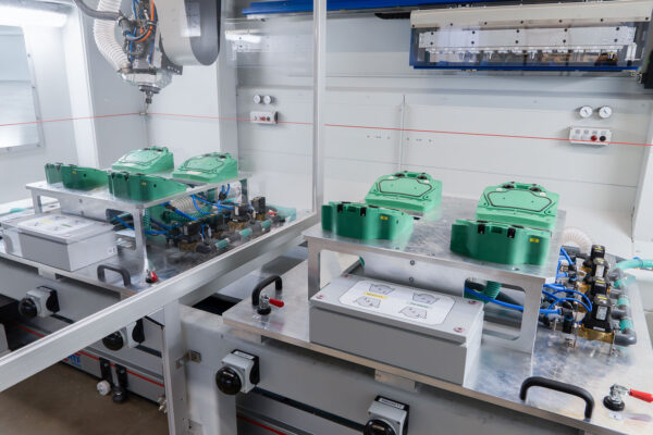 cnc-milling-machines-with-partition-wall-inside-with-view-on-fixtures-milling-spindle-and-barcode-scanner